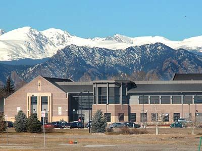 The Front of the library building with mountains visible in the distance