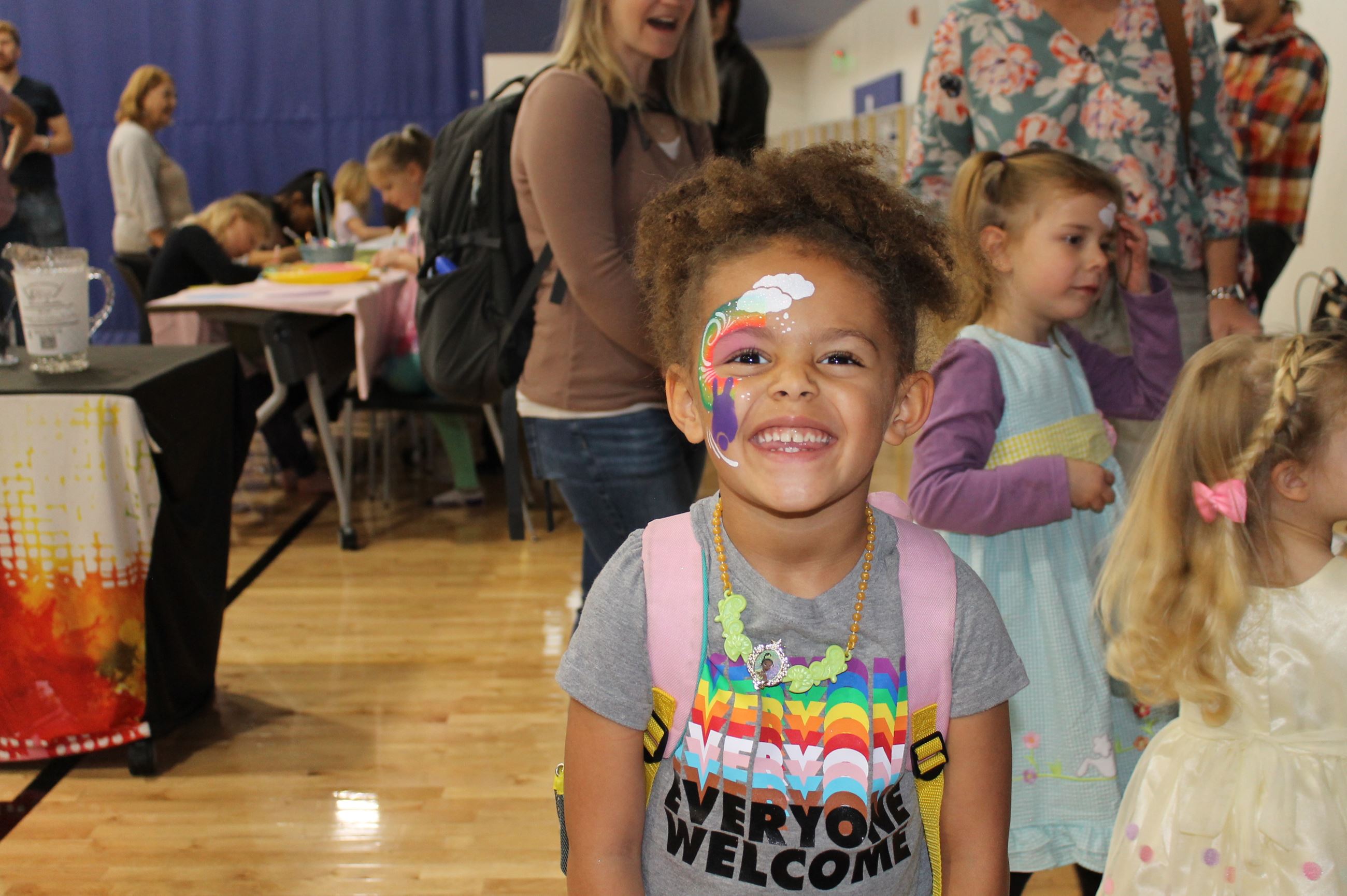 Smiling child with colorful face paint