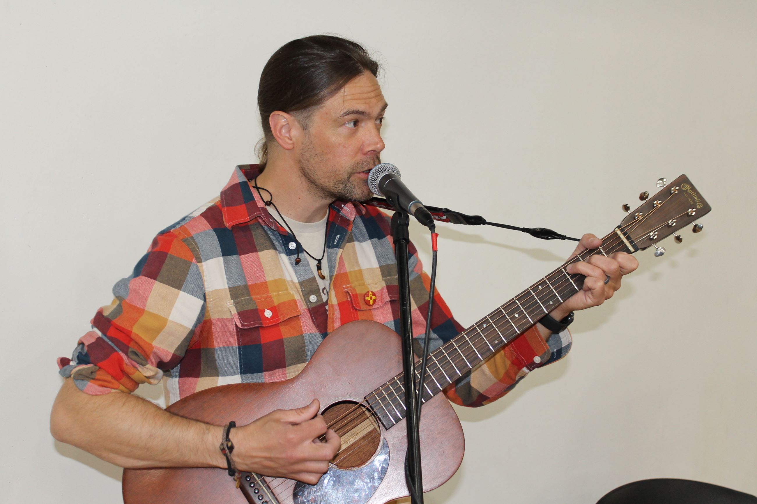 Guitar player singing into microphone