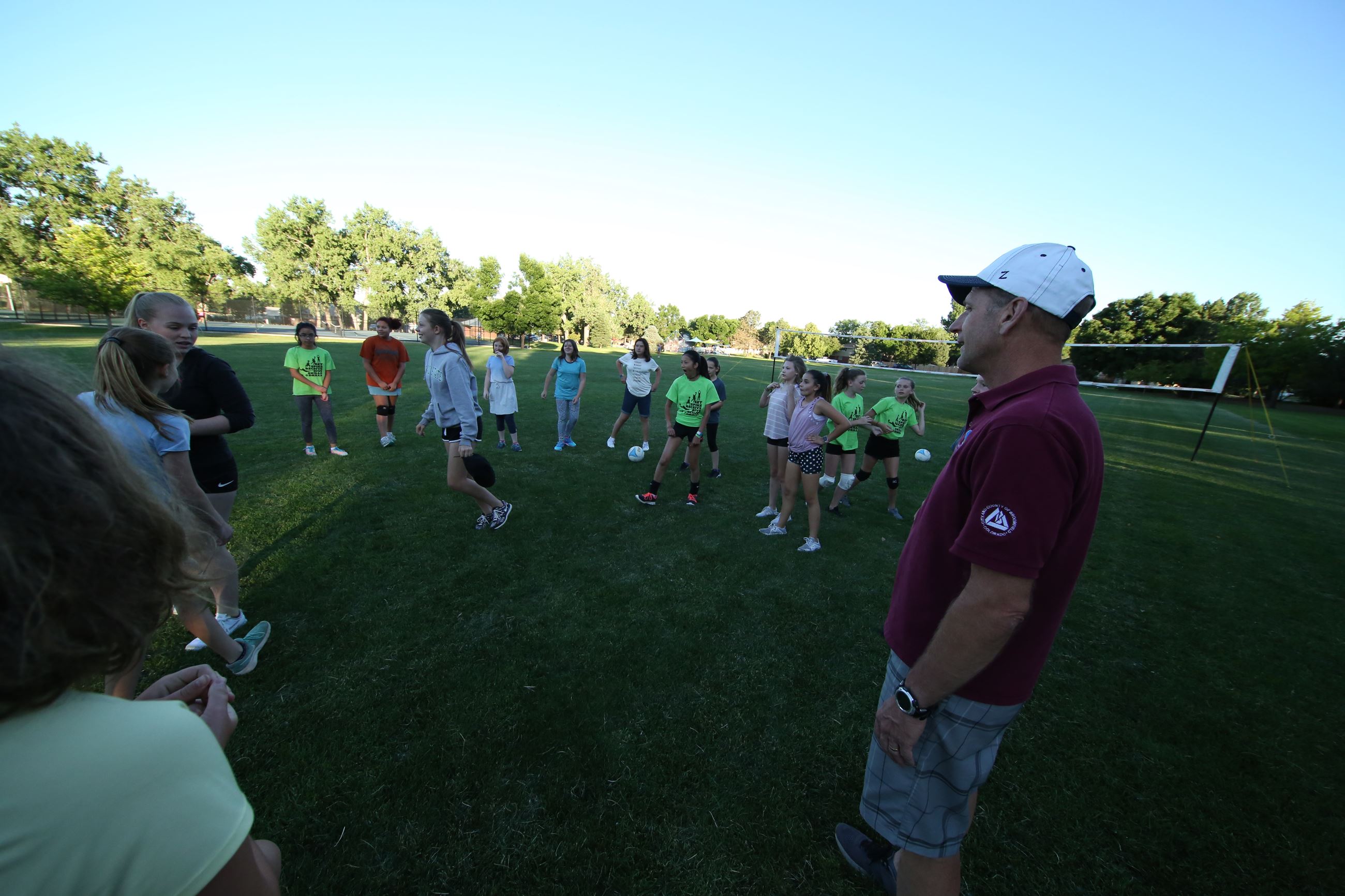 youth sport coach working with soccer kids