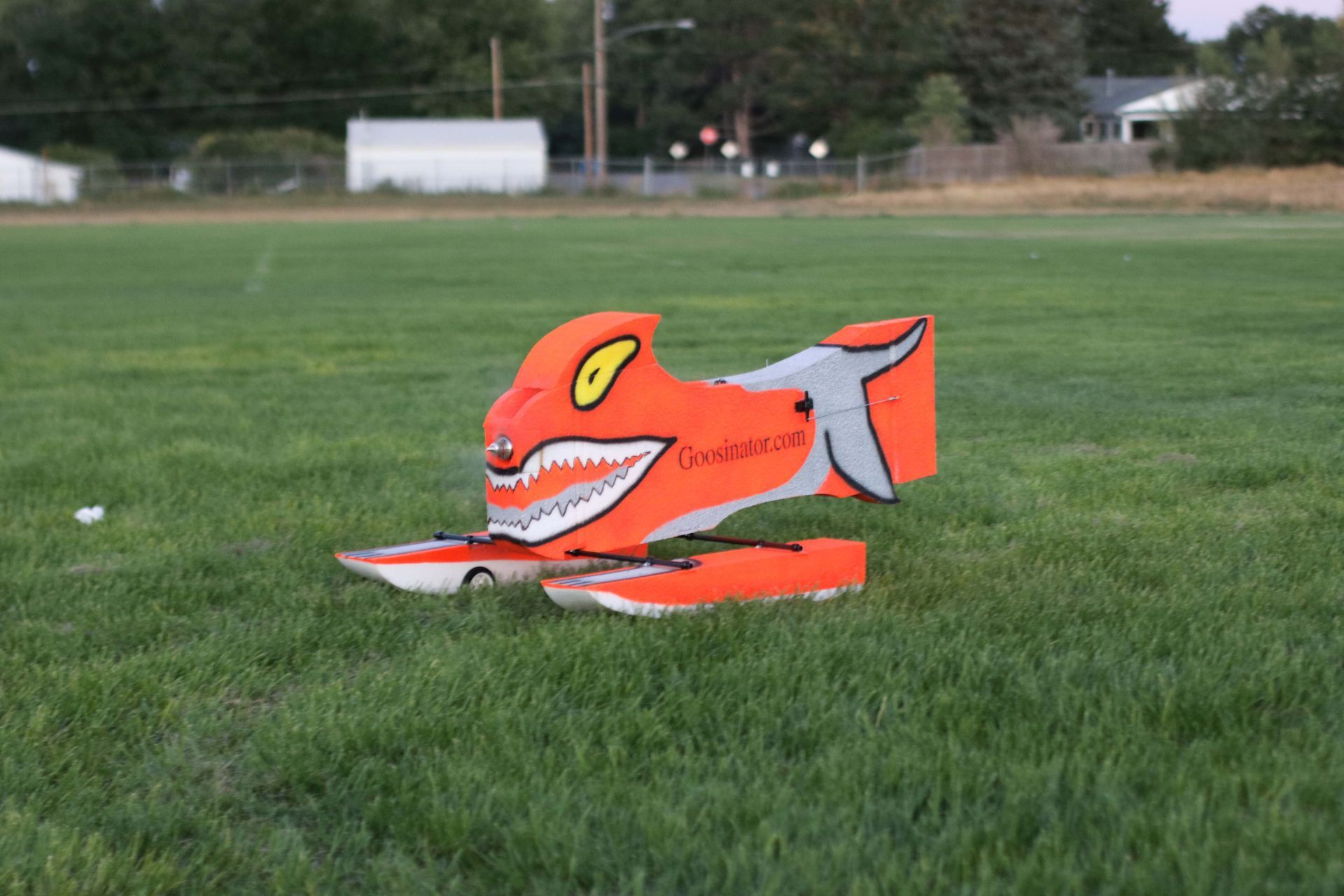 Orange floating Goosinator on a pond